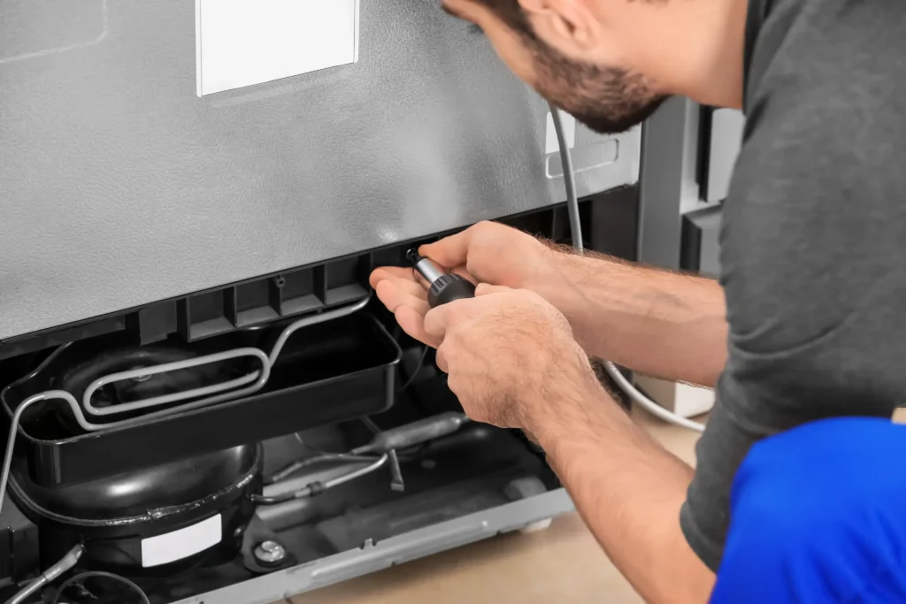 Image of a technician repairing an overheated refrigerator compressor in Verulam