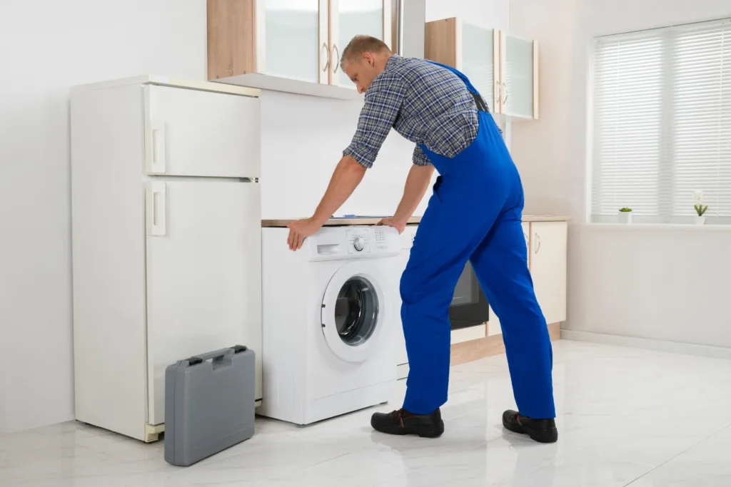: "Technician inspecting a washing machine for repair" appliance repair new germany
