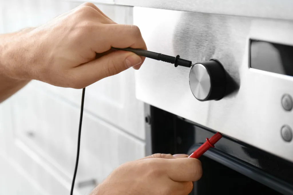 An oven technician is repairing a Siemens oven