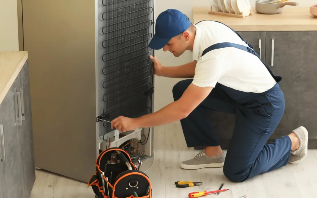 technician performing defy fridge repairs in ashburton