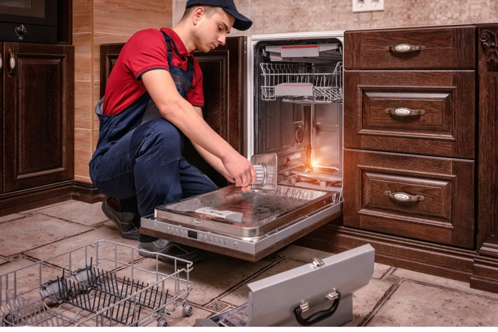 repair man performing dishwasher maintenance