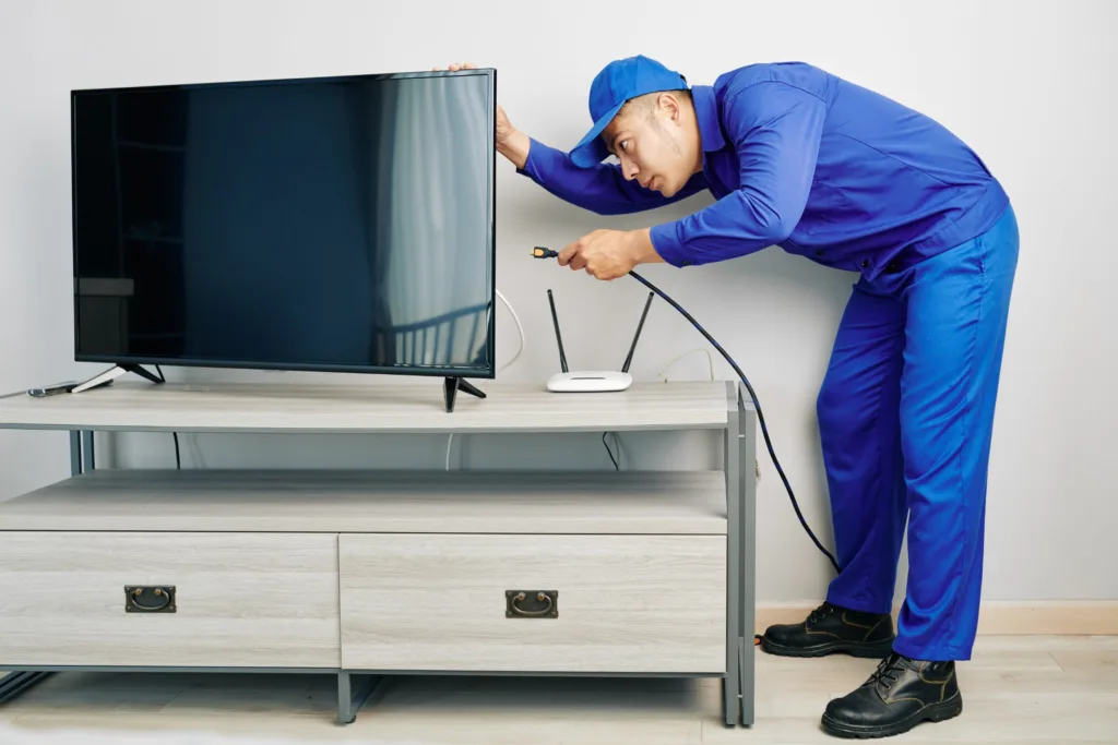 TV repair services in Westville: Fast and reliable solutions for your television. - image of a repairman fixing a tv