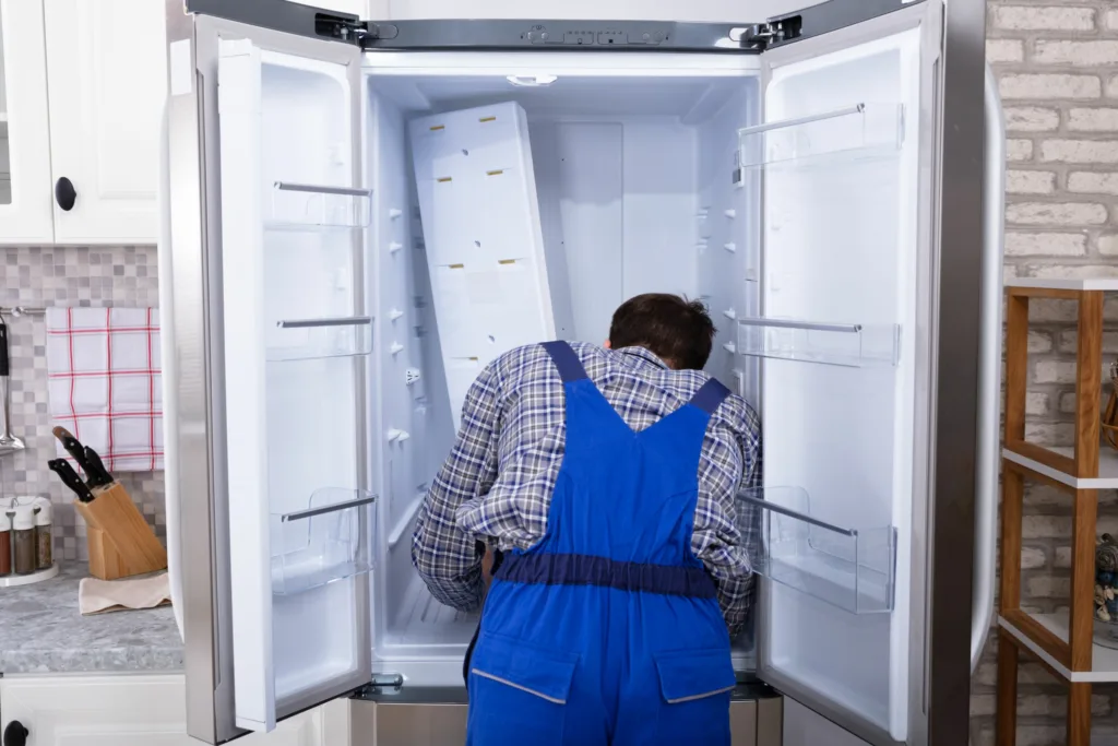 aeg fridge technician examines fridge for repairs in westville