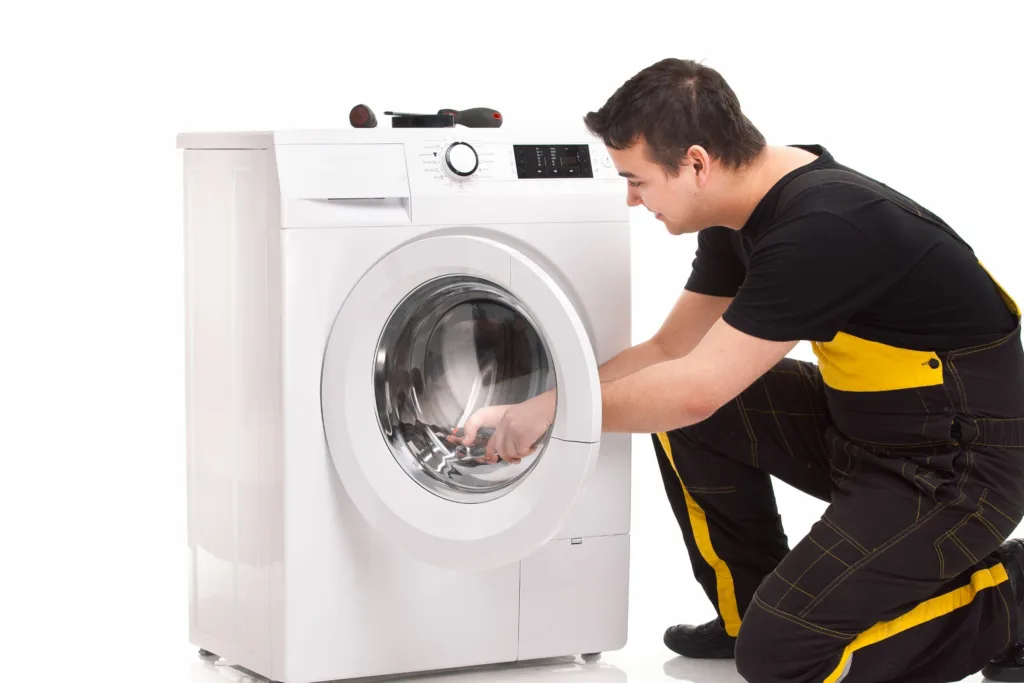 Technician repairing a broken washing machine in a Westville home