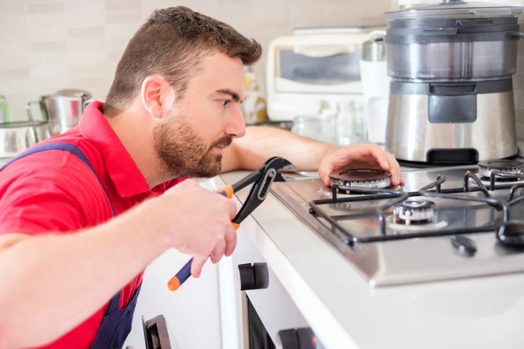 Smeg gas stove repair technician in Durban fixing a burner