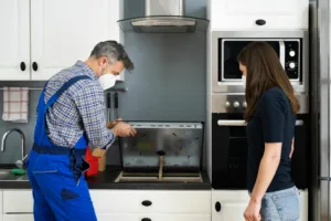 Technician fixing a samsung gas burner on a stove.