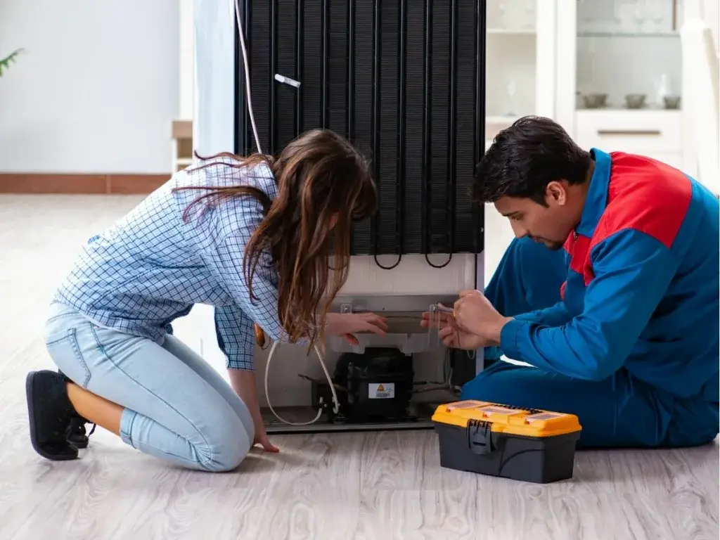 Technician repairing a Samsung refrigerator in a Durban, South Africa home.