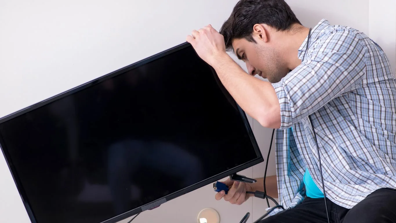 A technician repairing a plasma television in Durban North