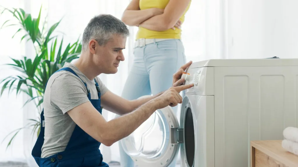 Samsung washing machine repair technician in Kloof, Durban, examining internal components for troubleshooting.