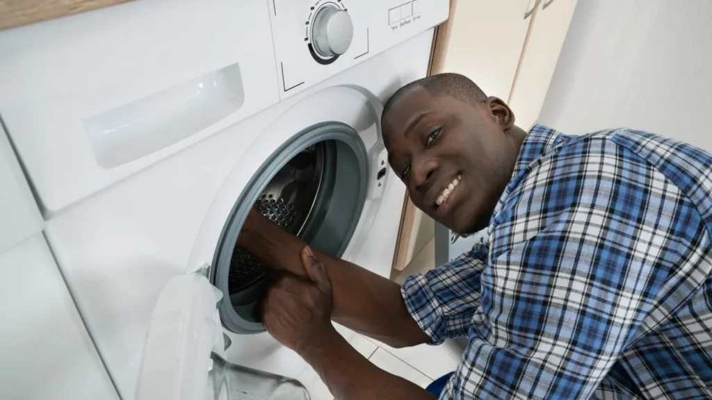 technician repairing a Samsung washing machine in a Durban home"