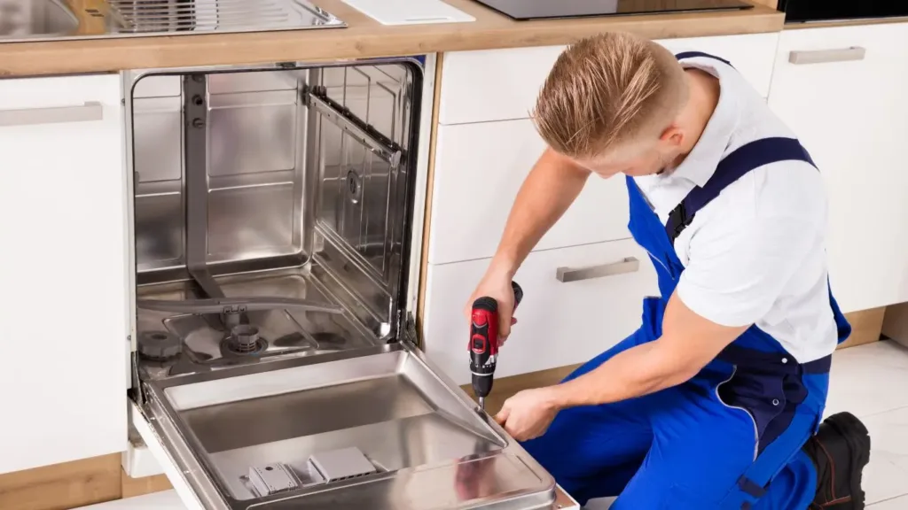 Technician diagnosing a faulty dishwasher in a Westville kitchen