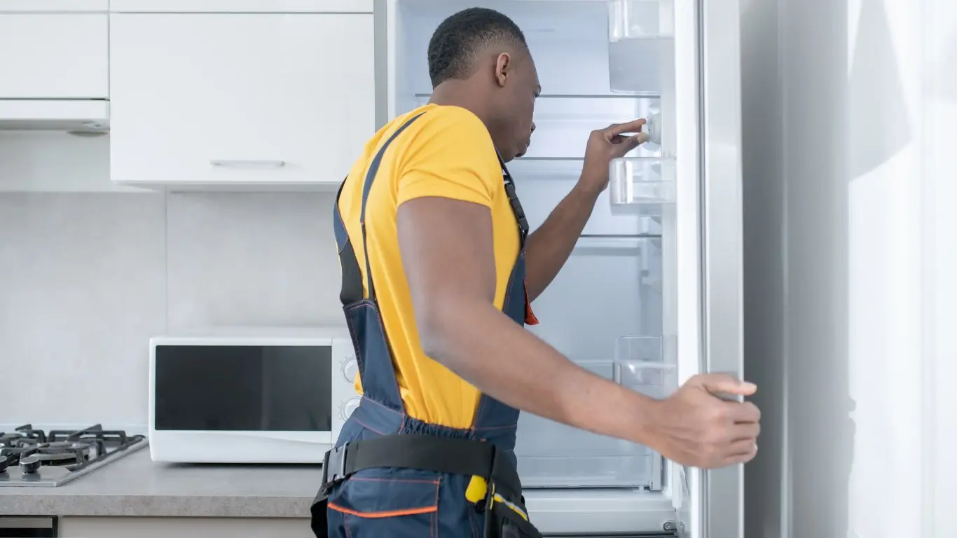 technician troubleshooting a defy refrigerator in Durban.