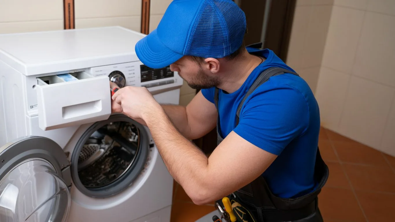 electrolux washing machine repairs Technician repairing an Electrolux washing machine in a durban home