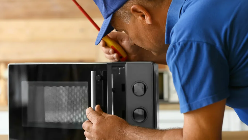 Technician repairing a microwave in Pinetown