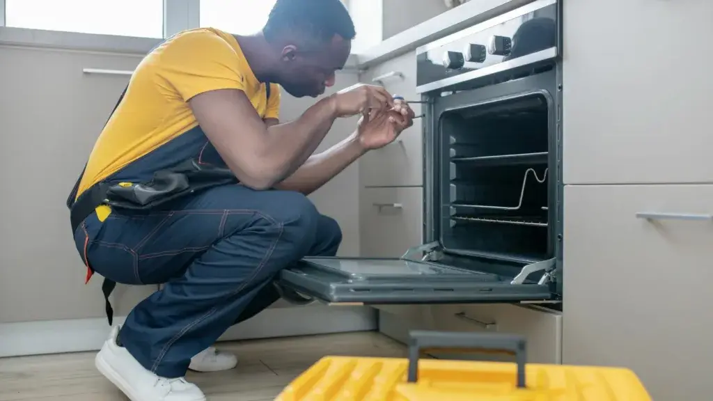 A Samsung customer service technician diagnosing a oven