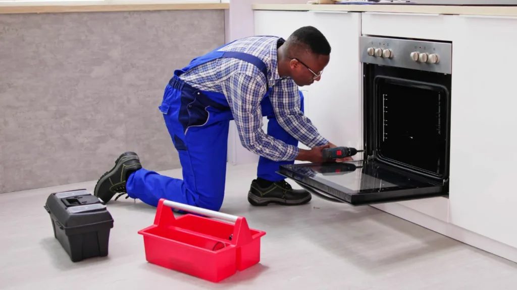 Skilled technician repairing a Smeg oven in a Durban kitchen