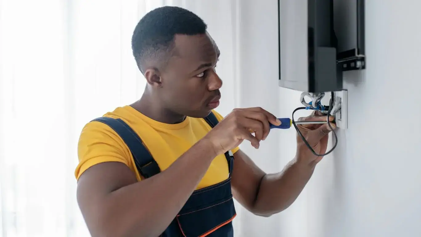 Technician on-site in Umhlanga repairing a wall-mounted TV.