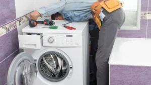 Technician servicing a tumble dryer in Verulam