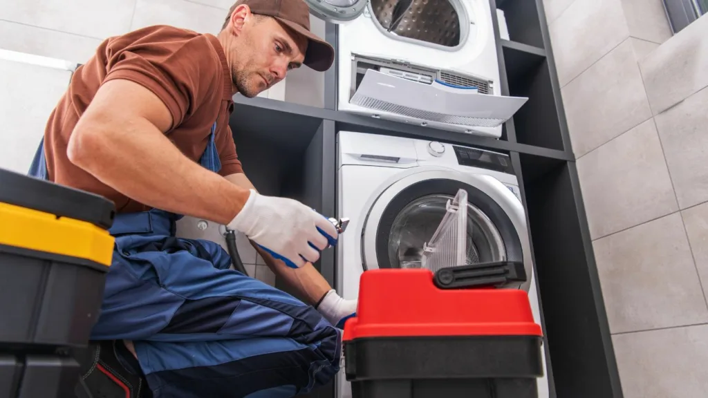 A technician repairing a washing machine in Waterfall.