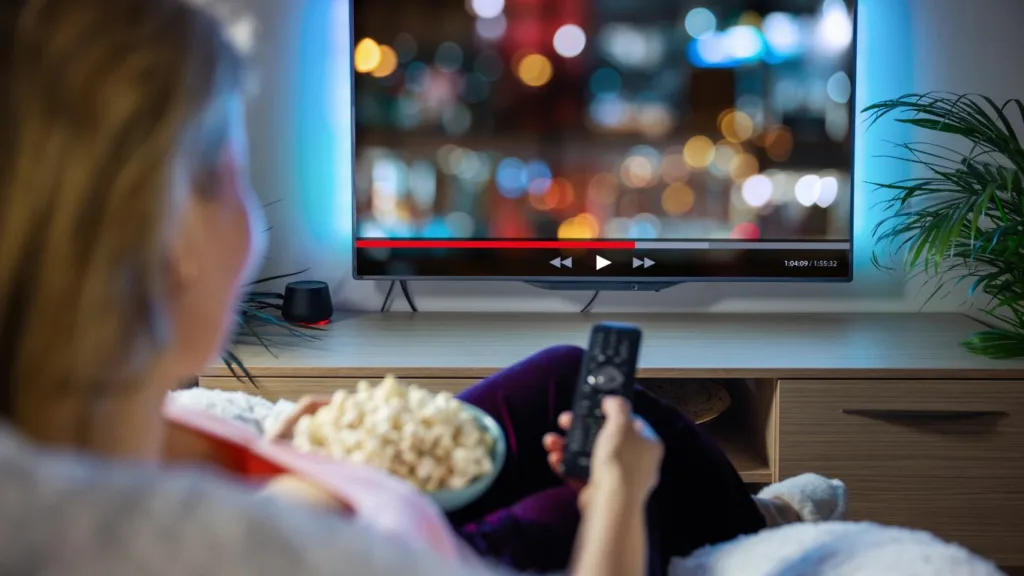 A customer smiling as they enjoy their fixed samsung tv