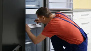 Fixing a broken AEG refrigerator in a kitchen.