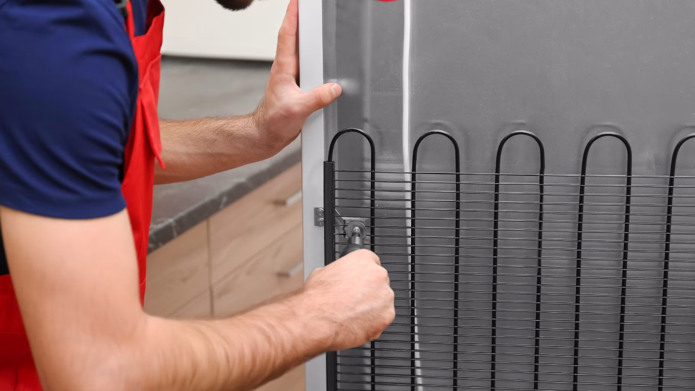 Refrigerator servicing Hillcrest Fridge repair specialist fixing a broken compressor in a Hillcrest residence.