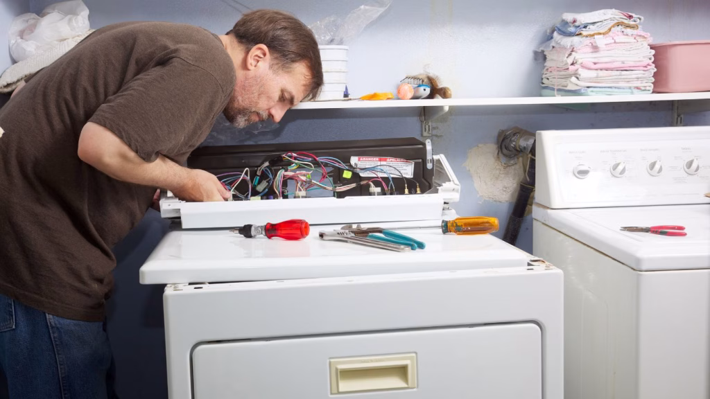Tumble dryer repair and service technician working on a dryer in Durban.