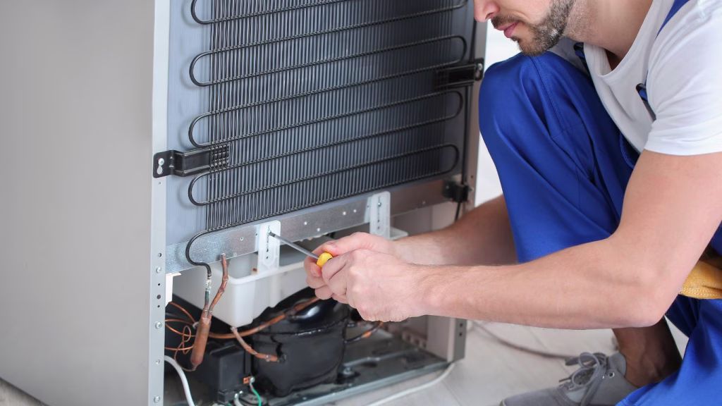 echnician working on a refrigerator, representing fridge repair services available in Sunningdale, Durban North.