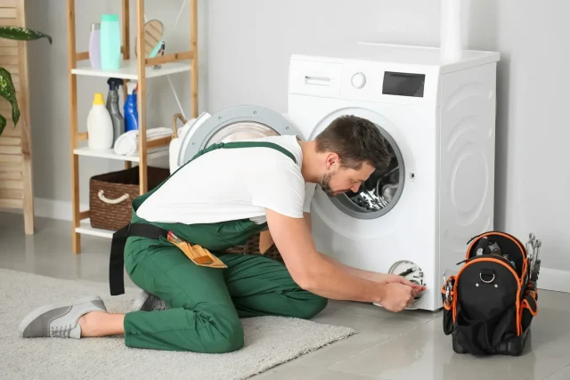 defy washing machine problems- technicians work on washing machine