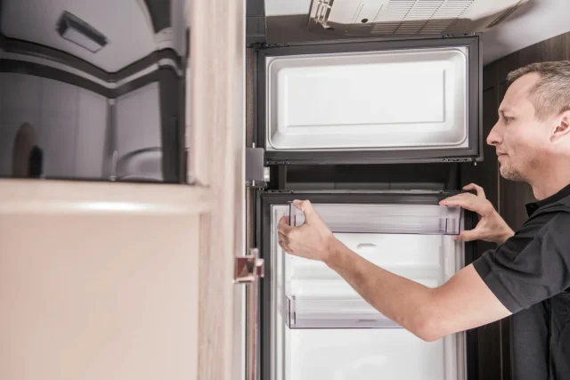 freezer stopped working - A technician is fixing a broken freezer.
