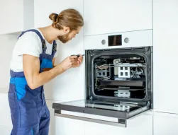 technician fixes oven in Durban North kitchen