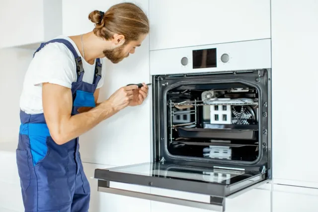 technician fixes oven in Durban North kitchen